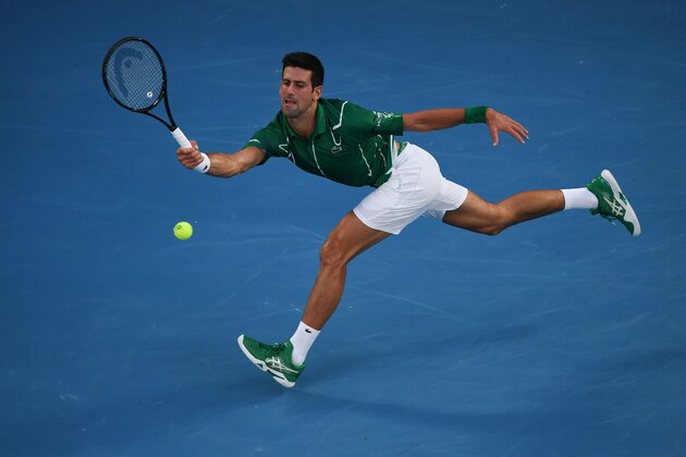 Serbia's Novak Djokovic hits a return against Switzerland's Roger Federer during their men's singles semi-final match on day eleven of the Australian Open tennis tournament in Melbourne on January 30, 2020. (Photo by Manan VATSYAYANA / AFP) / IMAGE RESTRICTED TO EDITORIAL USE - STRICTLY NO COMMERCIAL USE (Photo by MANAN VATSYAYANA/AFP via Getty Images)