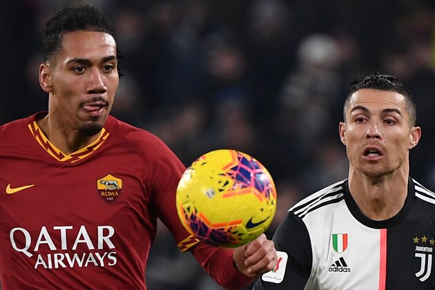 AS Roma's English defender Chris Smalling (L) and Juventus' Portuguese forward Cristiano Ronaldo eye the ball during the Italian Cup (Coppa Italia) round of 8 football match Juventus vs AS Roma on January 22, 2020 at the Juventus stadium in Turin. (Photo by Marco Bertorello / AFP) (Photo by MARCO BERTORELLO/AFP via Getty Images)