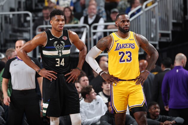 MILWAUKEE, WI - DECEMBER 19: Giannis Antetokounmpo #34 of the Milwaukee Bucks and LeBron James #23 of the Los Angeles Lakers look on during a game on December 19, 2019 at the Fiserv Forum Center in Milwaukee, Wisconsin. NOTE TO USER: User expressly acknowledges and agrees that, by downloading and or using this Photograph, user is consenting to the terms and conditions of the Getty Images License Agreement. Mandatory Copyright Notice: Copyright 2019 NBAE (Photo by Joe Murphy/NBAE via Getty Images).