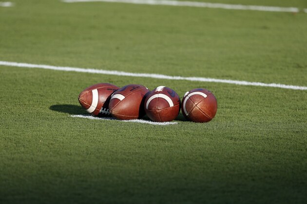 A group of footballs waits for warmups prior to an NCAA college football game between North Carolina State and the Ball State in Raleigh, N.C., Saturday, Sept. 21, 2019. (AP Photo/Karl B DeBlaker)