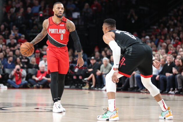 PORTLAND, OREGON - JANUARY 29: Damian Lillard #0 of the Portland Trail Blazers dribbles with the ball against Russell Westbrook #0 of the Houston Rockets in the first quarter  at Moda Center on January 29, 2020 in Portland, Oregon. NOTE TO USER: User expressly acknowledges and agrees that, by downloading and or using this photograph, User is consenting to the terms and conditions of the Getty Images License Agreement. (Photo by Abbie Parr/Getty Images)