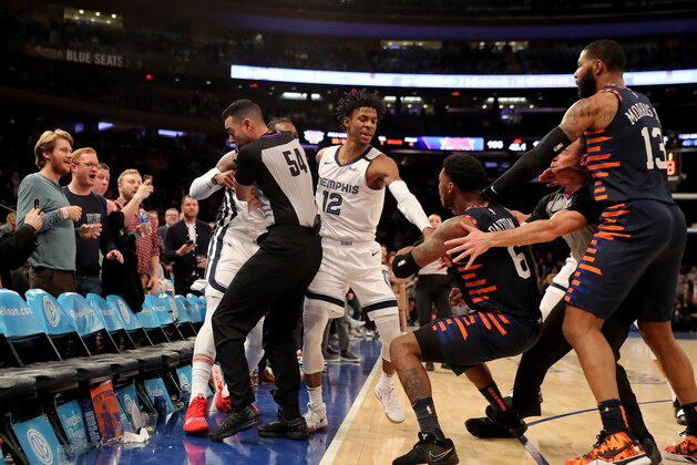 NEW YORK, NEW YORK - JANUARY 29:  The referees try to break up a fight between Jae Crowder #99 of the Memphis Grizzlies and Elfrid Payton #6 of the New York Knicks as the benches clear in the final minute of the game at Madison Square Garden on January 29, 2020 in New York City.The Memphis Grizzlies defeated the New York Knicks 127-106.NOTE TO USER: User expressly acknowledges and agrees that, by downloading and or using this photograph, User is consenting to the terms and conditions of the Getty Images License Agreement. (Photo by Elsa/Getty Images)