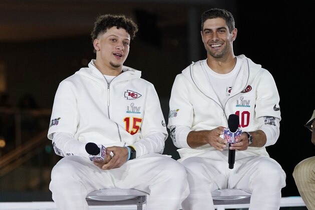 Kansas City Chiefs' Patrick Mahomes, right, chats with San Francisco 49ers' Jimmy Garoppolo during Opening Night for the NFL Super Bowl 54 football game Monday, Jan. 27, 2020, at Marlins Park in Miami. (AP Photo/David J. Phillip)