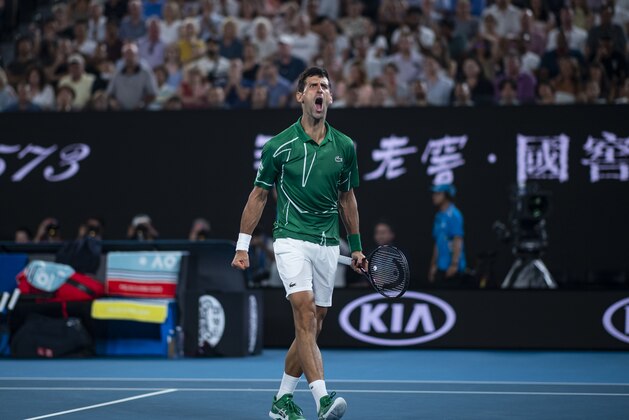 MELBOURNE, AUSTRALIA - JANUARY 30: Novak Djokovic of Serbia celebrates in his semi-final match against Roger Federer of Switzerland on day eleven of the 2020 Australian Open at Melbourne Park on January 30, 2020 in Melbourne, Australia. (Photo by TPN/Getty Images)
