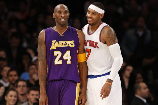 Los Angeles Lakers forward Kobe Bryant (24) chats with New York Knicks forward Carmelo Anthony (7) during a lull in play in the second half of an NBA basketball game at Madison Square Garden in New York, Sunday, Nov. 8, 2015.  The Knicks defeated the Lakers 99-95. (AP Photo/Kathy Willens)