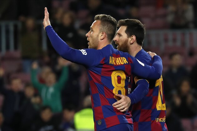 Barcelona's Arthur, left, celebrates with his teammate Lionel Messi after scoring his side's fourth goal during a Spanish Copa del Rey soccer match between Barcelona and Leganes at the Camp Nou stadium in Barcelona, Spain, Thursday, Jan. 30, 2020. (AP Photo/Joan Monfort)