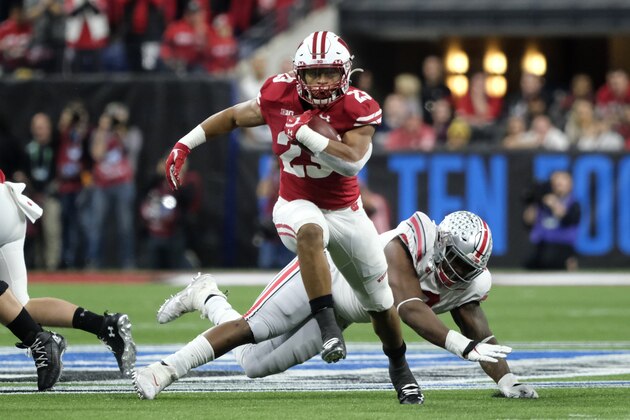Wisconsin running back Jonathan Taylor (23) runs past Ohio State defensive tackle Jashon Cornell (9) for a touchdown during the first half of the Big Ten championship NCAA college football game Saturday, Dec. 7, 2019, in Indianapolis. (AP Photo/AJ Mast)