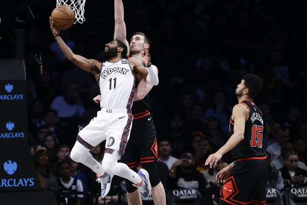 Brooklyn Nets' Kyrie Irving (11) drives past Chicago Bulls' Luke Kornet and Chandler Hutchison (15) during the first half of an NBA basketball game Friday, Jan. 31, 2020, in New York. (AP Photo/Frank Franklin II) Brooklyn Nets' Kyrie Irving (11) drives past Chicago Bulls' Luke Kornet and Chandler Hutchison (15) during the first half of an NBA basketball game Friday, Jan. 31, 2020, in New York. (AP Photo/Frank Franklin II)