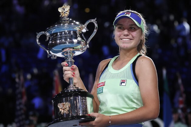 Sofia Kenin of the U.S. holds the Daphne Akhurst Memorial Cup aloft after defeating Spain's Garbine Muguruza in the womenÃ…fs singles final at the Australian Open tennis championship in Melbourne, Australia, Saturday, Feb. 1, 2020. (AP Photo/Lee Jin-man)