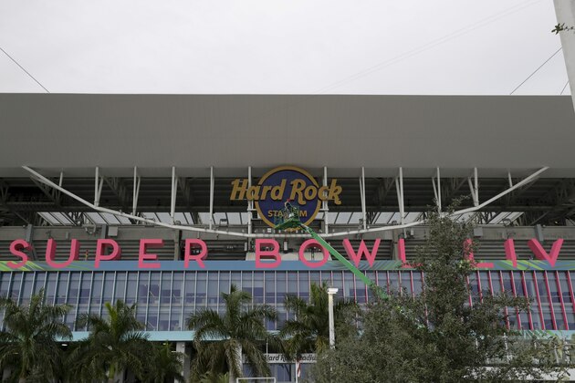 Workers string wire outside of the Hard Rock Stadium Monday, Jan. 27, 2020, in Miami Gardens, Fla. in preparation for the NFL Super Bowl 54 football game. (AP Photo/Chris Carlson)