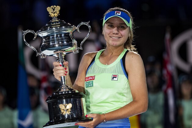MELBOURNE, AUSTRALIA - FEBRUARY 01: Sofia Kenin of the United States celebrates with the trophy after winning the women's singles final match against Garbine Muguruza of Spain on day thirteen of the 2020 Australian Open at Melbourne Park on February 01, 2020 in Melbourne, Australia. (Photo by TPN/Getty Images)