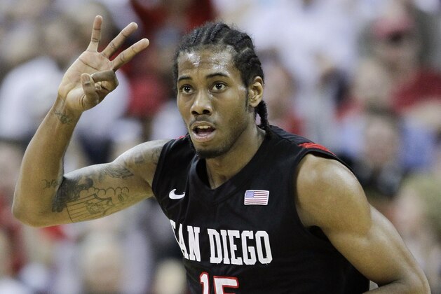 FILE- In this March 12, 2011, file photo, San Diego State's Kawhi Leonard gestures after hitting a 3-point basket during the first half of an NCAA college basketball championship game against BYU in the Mountain West Conference tournament in Las Vegas. Nine years after Leonard helped lead San Diego State to national prominence, the Aztecs will honor the greatest player in program history by hoisting his No. 15 jersey into the rafters at Viejas Arena, high above Steve Fisher Court on Saturday, Feb. 1, 2020. ((AP Photo/Julie Jacobson, File)