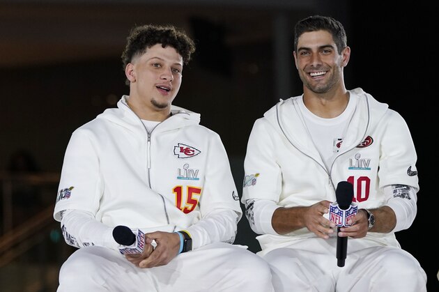 Kansas City Chiefs' Patrick Mahomes, right, chats with San Francisco 49ers' Jimmy Garoppolo during Opening Night for the NFL Super Bowl 54 football game Monday, Jan. 27, 2020, at Marlins Park in Miami. (AP Photo/David J. Phillip)