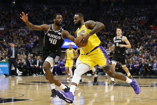 Los Angeles Lakers forward LeBron James, right, drives against Sacramento Kings forward Harrison Barnes during the first quarter of an NBA basketball game in Sacramento, Calif., Saturday, Feb. 1, 2020. (AP Photo/Rich Pedroncelli)