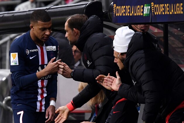 Paris Saint-Germain's French forward Kylian MBappe shakes hands with Paris Saint-Germain's German head coach  Thomas Tuchel (C) after his substitution  during the French League Cup round of sixteen football match between Le Mans FC and Paris Saint-Germain (PSG), on December 18, 2019, at the MMArena Stadium, in Le Mans, northwestern France. (Photo by FRANCK FIFE / AFP) (Photo by FRANCK FIFE/AFP via Getty Images)