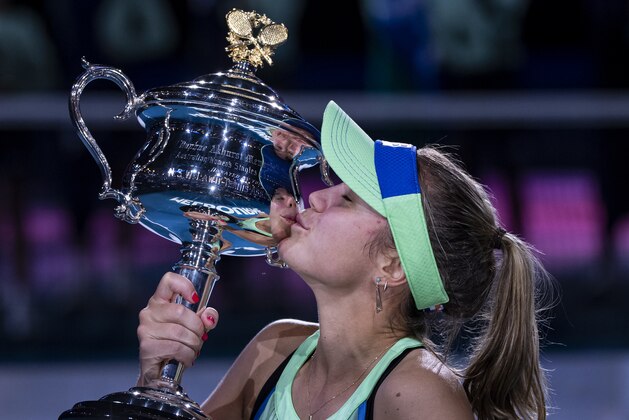 MELBOURNE, AUSTRALIA - FEBRUARY 01: Sofia Kenin of the United States celebrates with the trophy after winning the women's singles final match against Garbine Muguruza of Spain on day thirteen of the 2020 Australian Open at Melbourne Park on February 01, 2020 in Melbourne, Australia. (Photo by TPN/Getty Images)