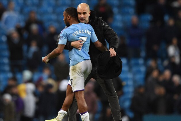 Manchester City's Spanish manager Pep Guardiola (R) greets Manchester City's English midfielder Raheem Sterling (L) at the end of the English Premier League football match between Manchester City and Manchester United at the Etihad Stadium in Manchester, north west England, on December 7, 2019. (Photo by Oli SCARFF / AFP) / RESTRICTED TO EDITORIAL USE. No use with unauthorized audio, video, data, fixture lists, club/league logos or 'live' services. Online in-match use limited to 120 images. An additional 40 images may be used in extra time. No video emulation. Social media in-match use limited to 120 images. An additional 40 images may be used in extra time. No use in betting publications, games or single club/league/player publications. /  (Photo by OLI SCARFF/AFP via Getty Images)