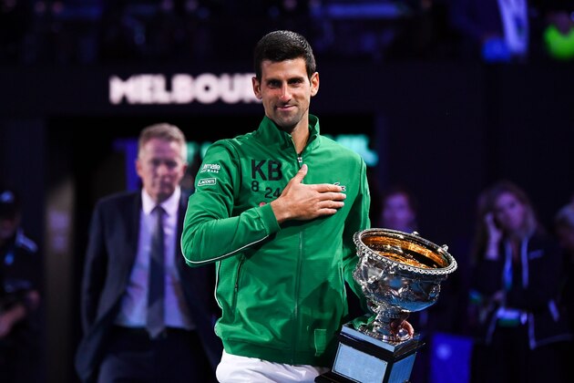 Serbia's Novak Djokovic poses with the Norman Brooks Challenge Cup trophy following his victory against Austria's Dominic Thiem in their men's singles final match on day fourteen of the Australian Open tennis tournament in Melbourne early on February 3, 2020. (Photo by William WEST / AFP) / IMAGE RESTRICTED TO EDITORIAL USE - STRICTLY NO COMMERCIAL USE (Photo by WILLIAM WEST/AFP via Getty Images)