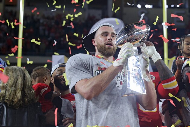 MIAMI, FLORIDA - FEBRUARY 02: Travis Kelce #87 of the Kansas City Chiefs raises the Vince Lombardi Trophy after defeating the San Francisco 49ers 31-20 in Super Bowl LIV at Hard Rock Stadium on February 02, 2020 in Miami, Florida. (Photo by Tom Pennington/Getty Images)