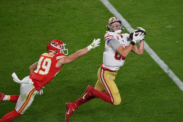 Free safety for the Kansas City Chiefs Daniel Sorensen (L) tries to block San Francisco 49ers tight end George Kittle from catching the ball during Super Bowl LIV between the Kansas City Chiefs and the San Francisco 49ers at Hard Rock Stadium in Miami Gardens, Florida, on February 2, 2020. (Photo by Angela Weiss / AFP) (Photo by ANGELA WEISS/AFP via Getty Images)