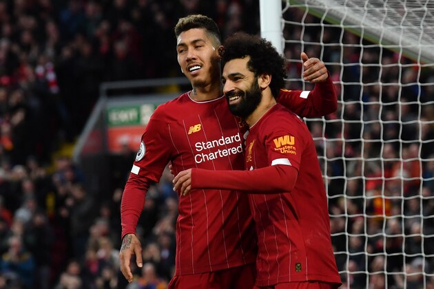 Liverpool's Egyptian midfielder Mohamed Salah (R) celebrates with Liverpool's Brazilian midfielder Roberto Firmino after scoring his team's third goal during the English Premier League football match between Liverpool and Southampton at Anfield in Liverpool, north west England on February 1, 2020. (Photo by Paul ELLIS / AFP) / RESTRICTED TO EDITORIAL USE. No use with unauthorized audio, video, data, fixture lists, club/league logos or 'live' services. Online in-match use limited to 120 images. An additional 40 images may be used in extra time. No video emulation. Social media in-match use limited to 120 images. An additional 40 images may be used in extra time. No use in betting publications, games or single club/league/player publications. /  (Photo by PAUL ELLIS/AFP via Getty Images)