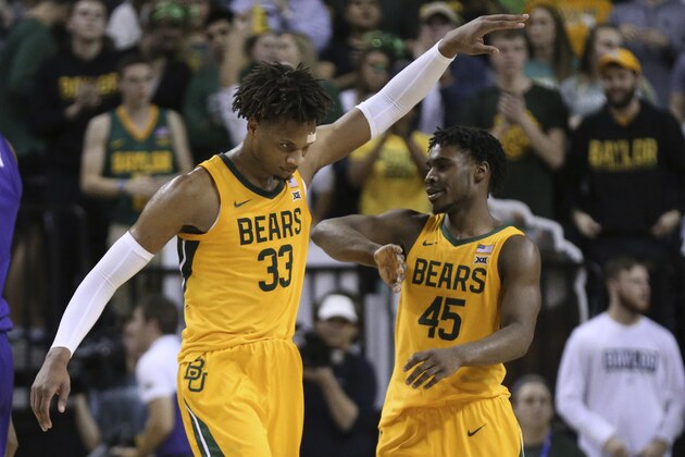Baylor forward Freddie Gillespie, left, celebrates with Baylor guard Davion Mitchell, right, after a call against TCU in the second half of an NCAA college basketball game, Saturday, Feb. 1, 2020, in Waco, Texas. Baylor won 68-52. (AP Photo/Rod Aydelotte)