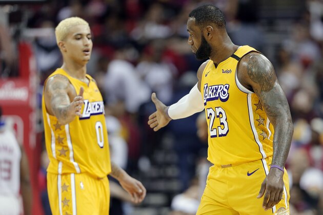 Los Angeles Lakers forwards Kyle Kuzma (0) and LeBron James (23) celebrate the team's impending win over the Houston Rockets, in the final minute of an NBA basketball game Saturday, Jan. 18, 2020, in Houston. (AP Photo/Michael Wyke) Los Angeles Lakers forwards Kyle Kuzma (0) and LeBron James (23) celebrate the team's impending win over the Houston Rockets, in the final minute of an NBA basketball game Saturday, Jan. 18, 2020, in Houston. (AP Photo/Michael Wyke)