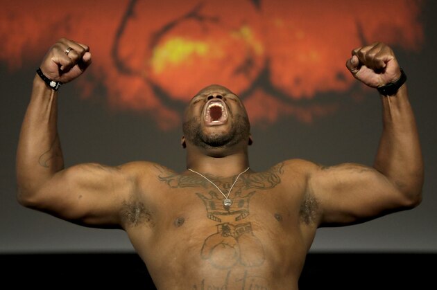 Derrick Lewis reacts while posing atop a scale prior to his heavyweight mixed martial arts bout against Daniel Cormier during the weigh-ins ahead of UFC 230, Friday, Nov. 2, 2018, at Madison Square Garden in New York. (AP Photo/Julio Cortez)