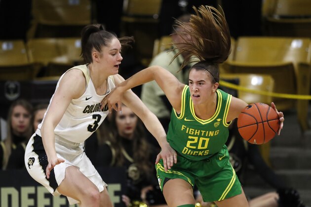 Oregon guard Sabrina Ionescu, right, drives past Colorado guard Emma Clarke in the second half of an NCAA college basketball game Saturday, Feb. 1, 2020, in Boulder, Colo. (AP Photo/David Zalubowski)