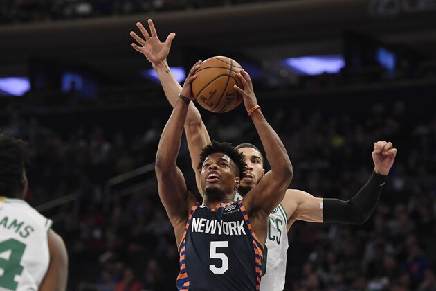 New York Knicks guard Dennis Smith Jr. (5) attempts a basket during the first half of an NBA basketball game against the Boston Celtics, Sunday, Dec. 1, 2019, in New York. (AP Photo/Sarah Stier)