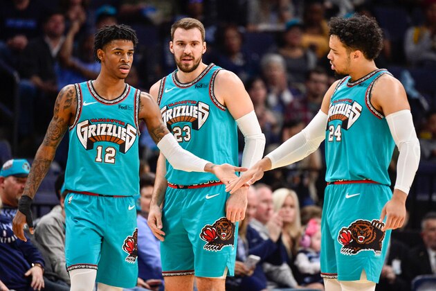 MEMPHIS, TN - NOVEMBER 29: Ja Morant #12 of the Memphis Grizzlies, Marko Guduric #23, and Dillon Brooks #24 of the Memphis Grizzlies greet each other on the court during the first half of a game against the Utah Jazz at FedExForum on November 29, 2019 in Memphis, Tennessee. NOTE TO USER: User expressly acknowledges and agrees that, by downloading and/or using this photograph, user is consenting to the terms and conditions of the Getty Images License Agreement. (Photo by Brandon Dill/Getty Images)