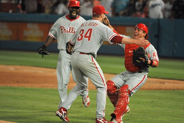 MIAMI, FL - MAY 29: Pitcher Roy Halladay #34 of the Philadelphia Phillies pitches celebrates with teammates Carlos Ruiz #51 and Ryan Howard #6 after pitching a perfect game against the Florida Marlins in Sun Life Stadium on May 29, 2010 in Miami, Florida. (Photo by Ronald C. Modra/Getty Images)