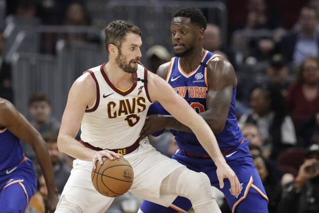 Cleveland Cavaliers' Kevin Love (0) derives past New York Knicks' Julius Randle (30) in the second half of an NBA basketball game, Monday, Feb. 3, 2020, in Cleveland. New York won 139-134 in overtime. (AP Photo/Tony Dejak)