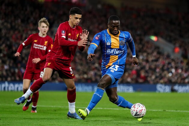 LIVERPOOL, ENGLAND - FEBRUARY 04:  Ki Jana Hoever of Liverpool and Daniel Udoh of Shrewsbury Town during the FA Cup Fourth Round Replay match between Liverpool and Shrewsbury at Anfield on February 4, 2020 in Liverpool, England. (Photo by James Baylis - AMA/Getty Images)