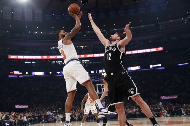 New York Knicks forward Marcus Morris Sr. (13) shoots with Brooklyn Nets forward Joe Harris (12) defending during the first half of an NBA basketball game in New York, Sunday, Jan. 26, 2020. (AP Photo/Kathy Willens) New York Knicks forward Marcus Morris Sr. (13) shoots with Brooklyn Nets forward Joe Harris (12) defending during the first half of an NBA basketball game in New York, Sunday, Jan. 26, 2020. (AP Photo/Kathy Willens)