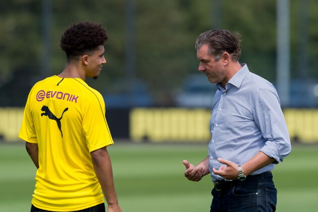 DORTMUND, GERMANY - JULY 09: Jadon Sancho of Dortmund speak wirh Michael Zorc of Dortmund during a training session at BVB trainings center on July 9, 2018 in Dortmund, Germany. (Photo by TF-Images/Getty Images) DORTMUND, GERMANY - JULY 09: Jadon Sancho of Dortmund speak wirh Michael Zorc of Dortmund during a training session at BVB trainings center on July 9, 2018 in Dortmund, Germany. (Photo by TF-Images/Getty Images)