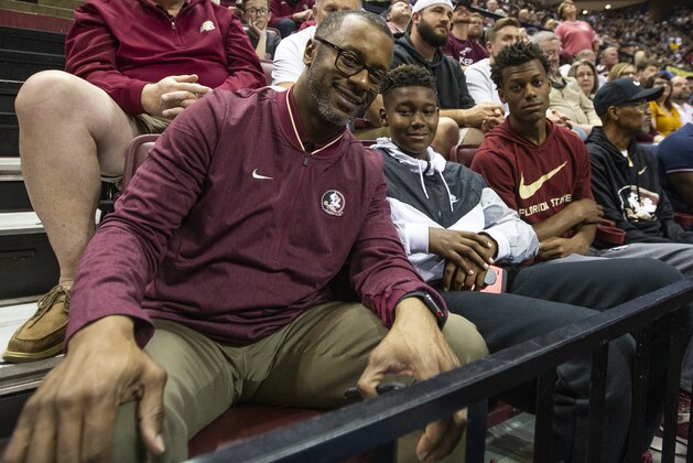 Florida State head football coach Willie Taggart watches the basketball game in the second half of an NCAA college basketball game against Duke with son's Jackson and Willie, Jr. in Tallahassee, Fla., Saturday, Jan. 12, 2019. Duke defeated Florida State 80-78. (AP Photo/Mark Wallheiser)