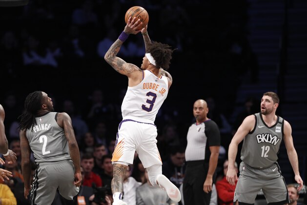 Phoenix Suns forward Kelly Oubre Jr. (3) shoots with Brooklyn Nets forward Taurean Prince (2) and Nets forward Joe Harris (12) looking on during the first quarter of an NBA basketball game, Monday, Feb. 3, 2020, in New York. (AP Photo/Kathy Willens)
