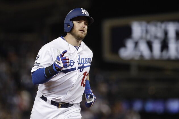 Los Angeles Dodgers' Max Muncy celebrates a run home run off Washington Nationals relief pitcher Sean Doolittle during the seventh inning in Game 2 of a baseball National League Division Series on Friday, Oct. 4, 2019, in Los Angeles. (AP Photo/Marcio Jose Sanchez)