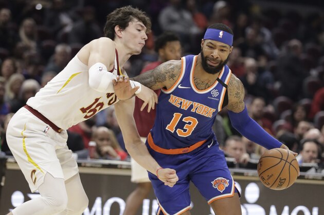 New York Knicks' Marcus Morris Sr. (13) drives to the basket against Cleveland Cavaliers' Cedi Osman (16) in the second half of an NBA basketball game, Monday, Feb. 3, 2020, in Cleveland. New York won 139-134 in overtime. (AP Photo/Tony Dejak)