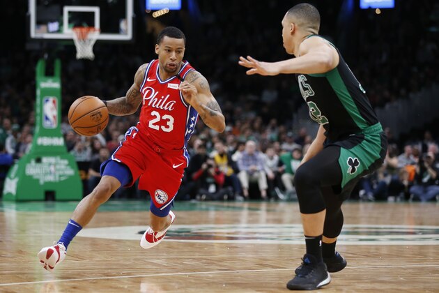 Philadelphia 76ers' Trey Burke (23) drives past Boston Celtics' Grant Williams (12) during the second half of an NBA basketball game in Boston, Saturday, Feb. 1, 2020. (AP Photo/Michael Dwyer)