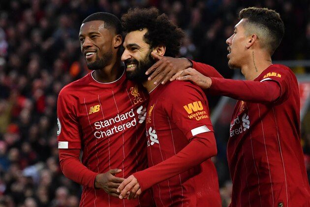 Liverpool's Egyptian midfielder Mohamed Salah (C) celebrates with teammates after scoring his team's third goal during the English Premier League football match between Liverpool and Southampton at Anfield in Liverpool, north west England on February 1, 2020. (Photo by Paul ELLIS / AFP) / RESTRICTED TO EDITORIAL USE. No use with unauthorized audio, video, data, fixture lists, club/league logos or 'live' services. Online in-match use limited to 120 images. An additional 40 images may be used in extra time. No video emulation. Social media in-match use limited to 120 images. An additional 40 images may be used in extra time. No use in betting publications, games or single club/league/player publications. /  (Photo by PAUL ELLIS/AFP via Getty Images)