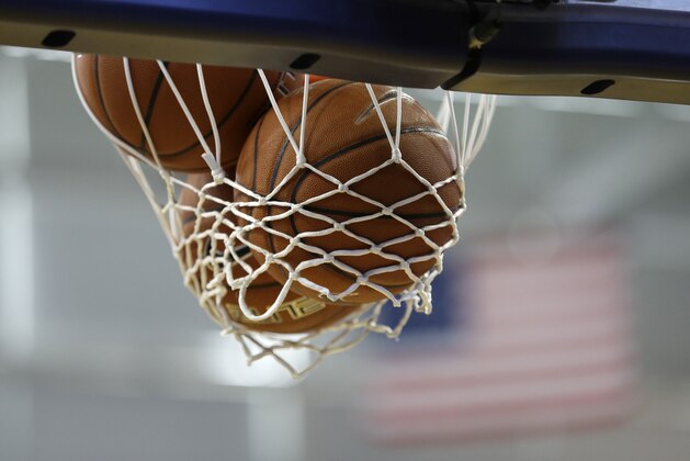 Basketballs sit stuck in the net before an NCAA college basketball game between Northern Iowa and North Carolina, Saturday, Nov. 21, 2015, in Cedar Falls, Iowa. (AP Photo/Charlie Neibergall)