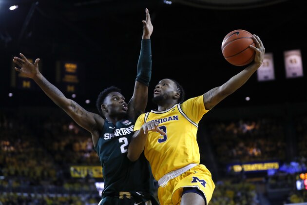 Michigan guard Zavier Simpson (3) drives on Michigan State guard Rocket Watts (2) in the second half of an NCAA college basketball game in Ann Arbor, Mich., Saturday, Feb. 8, 2020. (AP Photo/Paul Sancya)