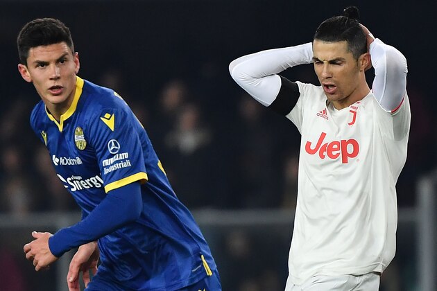 Juventus' Portuguese forward Cristiano Ronaldo  (R) reacts during the Italian Serie A football match Hellas Verona vs Juventus on February 8, 2020, at the Marcantonio Bentegodi Stadium in Verona. (Photo by MARCO BERTORELLO / AFP) (Photo by MARCO BERTORELLO/AFP via Getty Images)