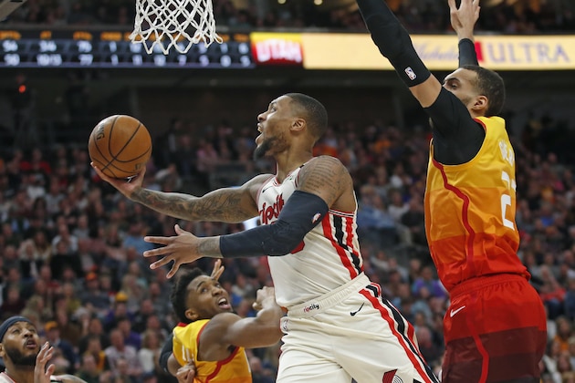 Portland Trail Blazers guard Damian Lillard lays the ball up as Utah Jazz's Rudy Gobert, right, and Donovan Mitchell, rear, defend in the first half during an NBA basketball game Friday, Feb. 7, 2020, in Salt Lake City. (AP Photo/Rick Bowmer) Portland Trail Blazers guard Damian Lillard lays the ball up as Utah Jazz's Rudy Gobert, right, and Donovan Mitchell, rear, defend in the first half during an NBA basketball game Friday, Feb. 7, 2020, in Salt Lake City. (AP Photo/Rick Bowmer)