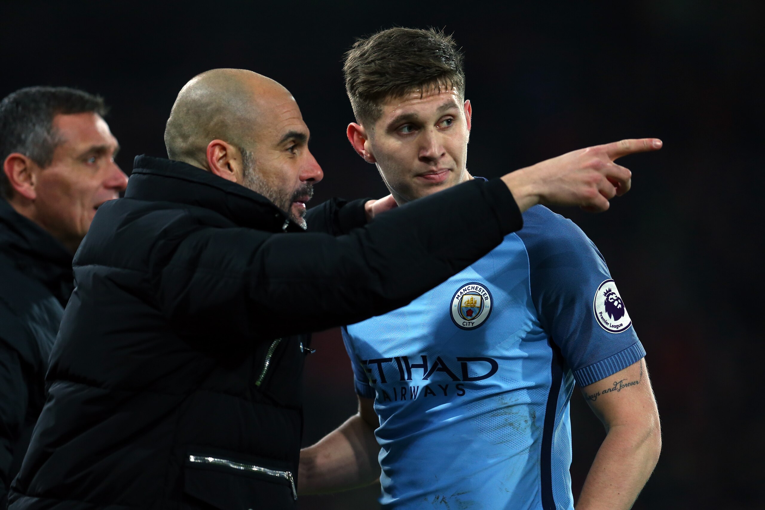 BOURNEMOUTH, ENGLAND - FEBRUARY 13: Pep Guardiola the manager of Manchester City talks to John Stones of Manchester City during the Premier League match between AFC Bournemouth and Manchester City at Vitality Stadium on February 13, 2017 in Bournemouth, England. (Photo by Catherine Ivill - AMA/Getty Images)