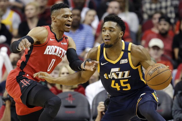 Utah Jazz guard Donovan Mitchell (45) dribbles as Houston Rockets guard Russell Westbrook defends during the first half of an NBA basketball game, Sunday, Feb. 9, 2020, in Houston. (AP Photo/Eric Christian Smith) Utah Jazz guard Donovan Mitchell (45) dribbles as Houston Rockets guard Russell Westbrook defends during the first half of an NBA basketball game, Sunday, Feb. 9, 2020, in Houston. (AP Photo/Eric Christian Smith)