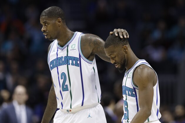 Charlotte Hornets' Marvin Williams (2) puts his hand on Kemba Walker's head during a timeout in the second half of an NBA basketball game against the New York Knicks in Charlotte, N.C., Friday, Dec. 14, 2018. New York won 126-124 in overtime. (AP Photo/Chuck Burton)