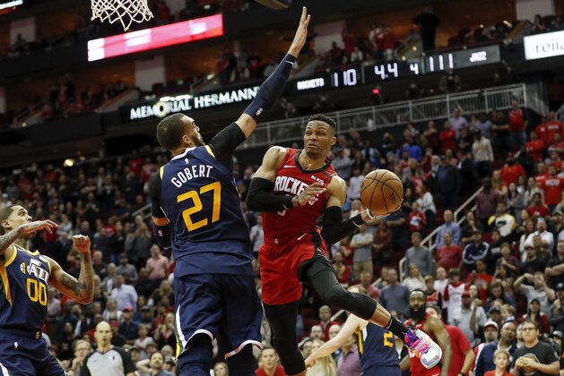 HOUSTON, TEXAS - FEBRUARY 09: Russell Westbrook #0 of the Houston Rockets drives to the basket defended by Rudy Gobert #27 of the Utah Jazz in the fourth quarter at Toyota Center on February 09, 2020 in Houston, Texas.  NOTE TO USER: User expressly acknowledges and agrees that, by downloading and or using this photograph, User is consenting to the terms and conditions of the Getty Images License Agreement. (Photo by Tim Warner/Getty Images)